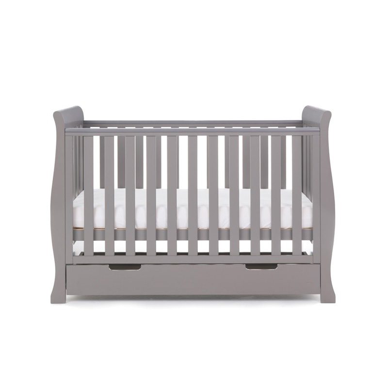 The taupe grey Obaby Stamford Mini Sleigh Cot Bed with an adjustable platform at a medium level | Cots, Cot Beds, Toddler & Kid Beds | Nursery Furniture - Clair de Lune UK