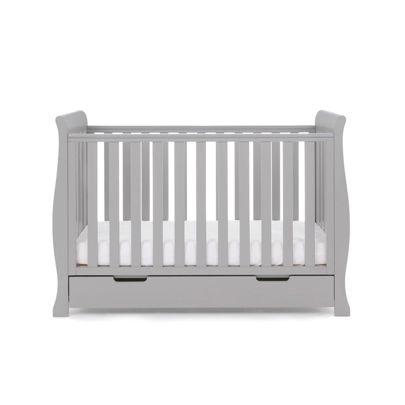 The warm grey Obaby Stamford Mini Sleigh Cot Bed with an adjustable platform at the lowest level | Cots, Cot Beds, Toddler & Kid Beds | Nursery Furniture - Clair de Lune UK