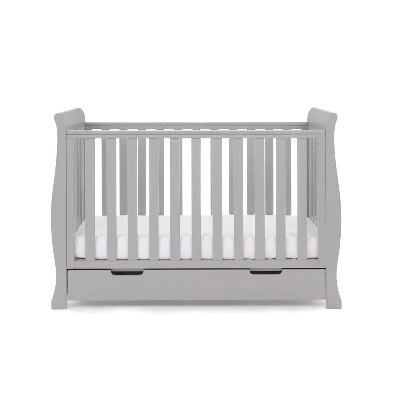 The cot bed of the Warm Grey Obaby Stamford Mini 3 Piece Room Set with the adjustable platform on the lowest level | Nursery Furniture Sets | Room Sets | Nursery Furniture - Clair de Lune UK