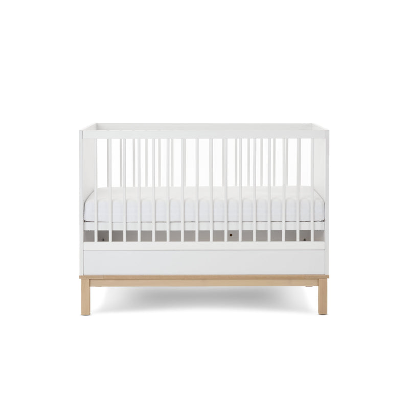 The cot bed of the White and Natural Obaby Astrid Mini 2 Piece Room Set with an adjustable platform at a medium level | Nursery Furniture Sets | Room Sets | Nursery Furniture - Clair de Lune UK