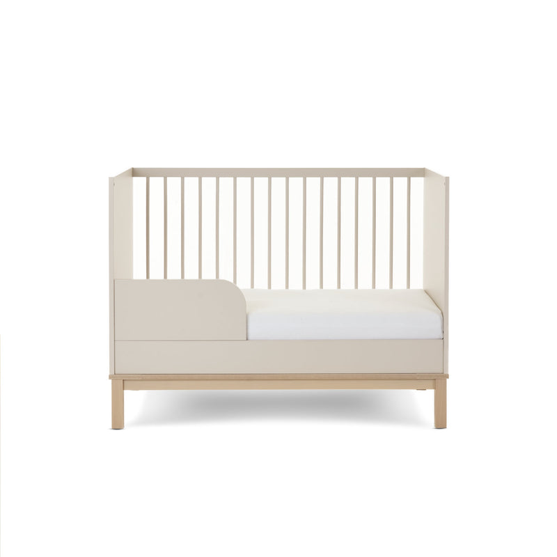 The cot bed of the Natural Cashmere Obaby Astrid Mini 3 Piece Room Set when transformed to a toddler bed with a toddler rail | Nursery Furniture Sets | Room Sets | Nursery Furniture - Clair de Lune UK