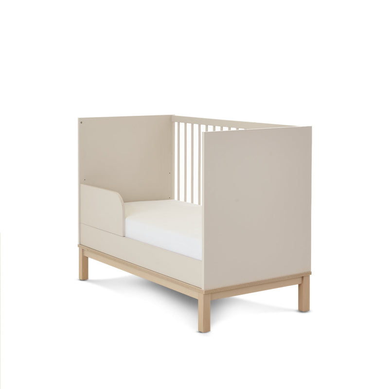 The side of the Cashmere Natural Obaby Astrid Mini Cot Bed when transformed to a toddler bed with a toddler rail | Cots, Cot Beds, Toddler & Kid Beds | Nursery Furniture - Clair de Lune UK