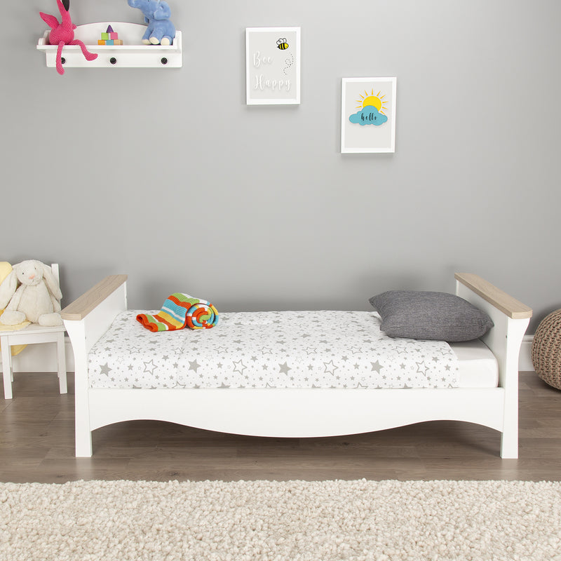  The cot bed transformed to a toddler bed of the White and Ash CuddleCo Clara 2pc Nursery Set - 3 Drawer Dresser/Changer & Cot Bed in a grey gender-neutral nursery | Nursery Furniture Sets | Room Sets | Nursery Furniture - Clair de Lune UK