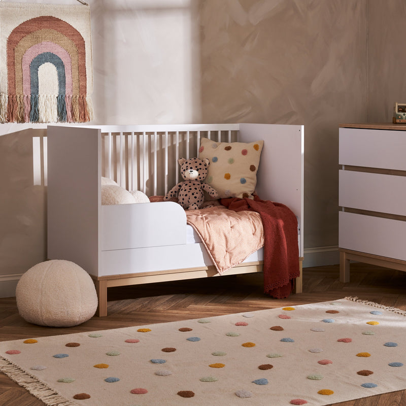 The white and natural Obaby Astrid Mini Cot Bed transferred to a toddler bed in a cream Scandi jungle safari inspired nursery room | Cots, Cot Beds, Toddler & Kid Beds | Nursery Furniture - Clair de Lune UK