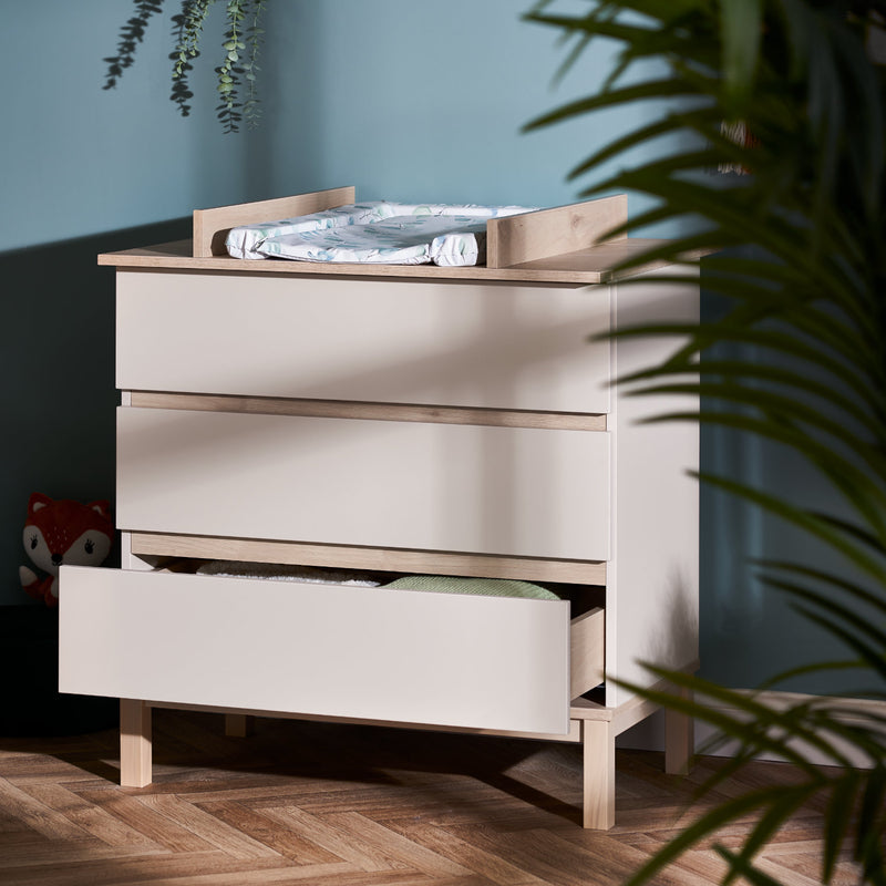 The changer of the cot bed of the Natural Cashmere Obaby Astrid Mini 3 Piece Room Set in a Scandi pastel green nursery room | Nursery Furniture Sets | Room Sets | Nursery Furniture - Clair de Lune UK