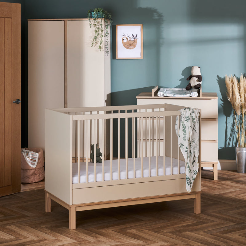 Natural Cashmere Obaby Astrid Mini 3 Piece Room Set including a natural changer, a matching wardrobe and a matching cot bed transformed to a toddler bed in a Scandi pastel green nursery room | Nursery Furniture Sets | Room Sets | Nursery Furniture - Clair