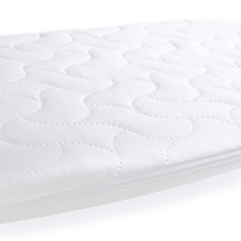 The water-resistant cover of the Quilted Microfibre Bedside Crib Mattress (76 x 40 cm) | Bedside & Folding Crib Mattresses | Baby Mattresses | Bedding | Nursery Furniture - Clair de Lune UK