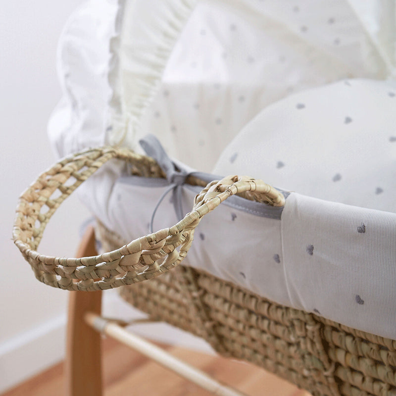 Lullaby Hearts Palm Moses Basket showcasing the sturdy palm handle and basket with the delicately embroidered grey heart fabrics | Co-sleepers | Nursery Furniture - Clair de Lune UK