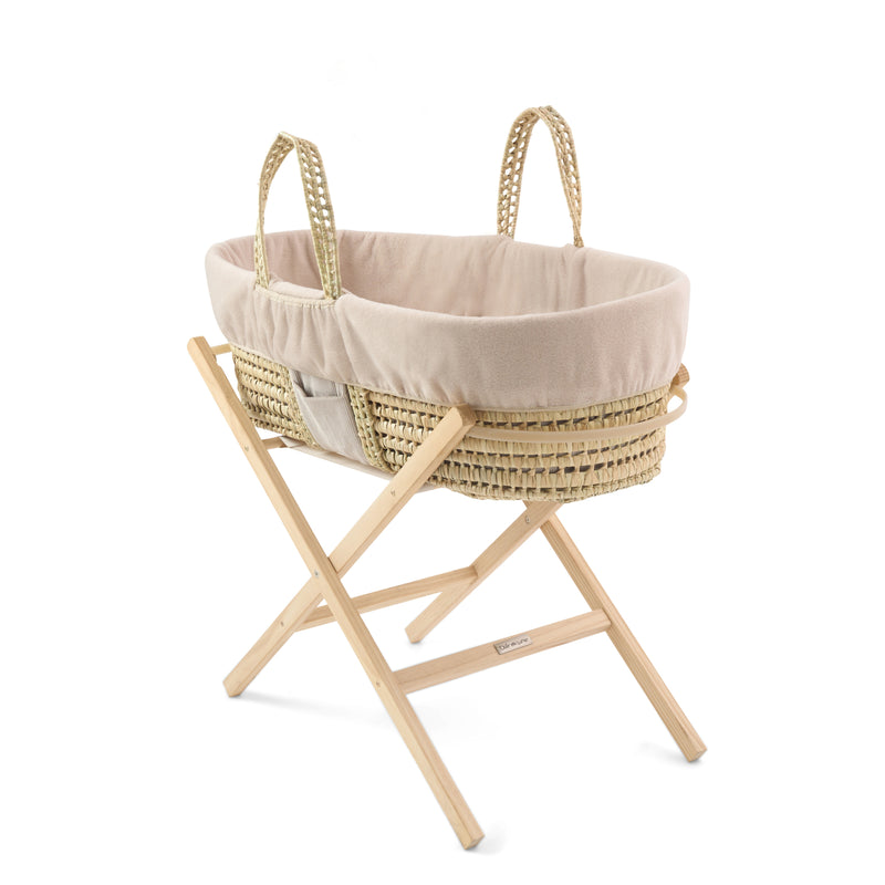 The pocket side of the Reversible Cord Moses Basket Dressing on the sturdy palm Moses basket on a natural folding stand | Moses Basket Dressings | Bedding Sets - Clair de Lune UK