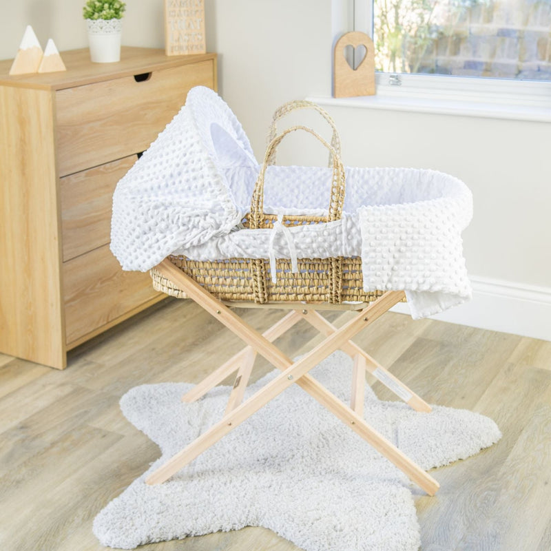 White Dimple Palm Moses Basket on the Natural Compact Folding Stand in a minimalist bedroom | Moses Baskets and Stands | Co-sleepers | Nursery Furniture - Clair de Lune UK