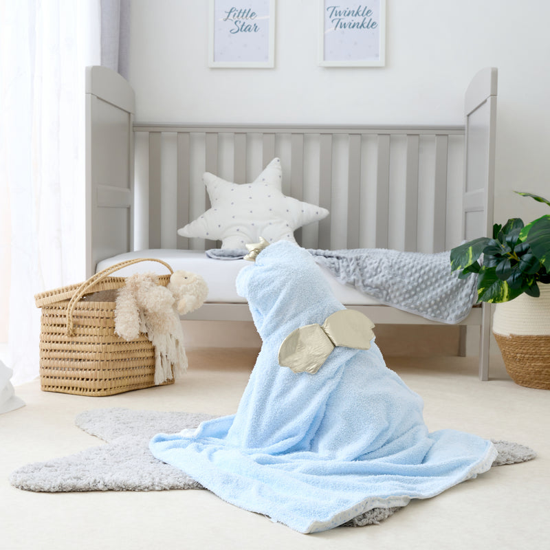 Little girl wearing the Little Bear Hooded Blanket in Blue showing the gold wings at the back | Cosy Baby Blankets | Nursery Bedding | Newborn, Baby and Toddler Essentials - Clair de Lune UK