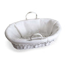 The side of the Quilted Liner for Moses Basket on a white wicker Moses basket | Moses Baby Basket Dressing | Nursery Bedding | Moses Basket Accessories  - Clair de Lune UK