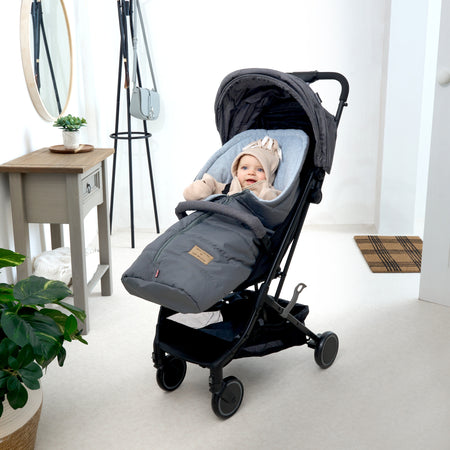 Baby snuggling in the grey Cocoon Pushchair Footmuff | Pushchair Cosytoes & Footmuffs | Travel Accessories - Clair de Lune UK