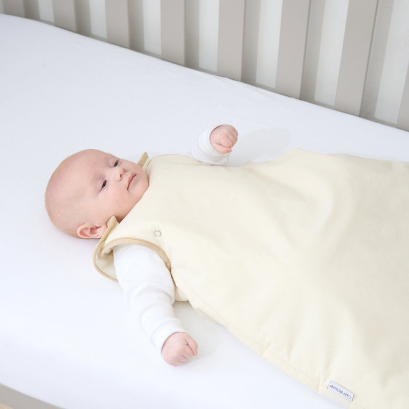 Happy baby in the Natural Cream Organic Sleeping Bag (0-6 Months) | Baby Sleeping Bags | Nightwear - Clair de Lune UK