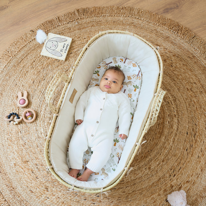 Baby playing in the Sandshell Savannah Palm Moses Basket | Moses Baskets | Co-sleepers | Nursery Furniture - Clair de Lune UK