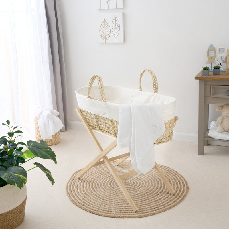 Cream Scandi Palm Moses Basket on the Clair de Lune Natural Compact Folding Moses Stand and with the white Pram Cellular Blanket | Moses Baskets and Stands | Co-sleepers | Nursery Furniture - Clair de Lune UK