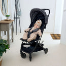 Baby wearing the oatmeal Star Fleece Baby Wrap Blanket strapped in the pram ready for a chilly walk | Cosy Baby Blankets | Swaddle Blanket | Nursery Bedding - Clair de Lune UK