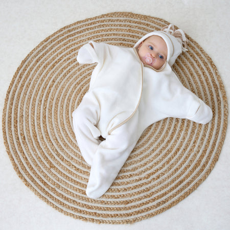 Baby wearing the cream Star Fleece Baby Wrap Blanket | Cosy Baby Blankets | Nursery Bedding | Newborn, Baby and Toddler Essentials - Clair de Lune UK
