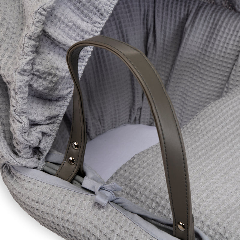 Grey Waffle Grey Wicker Moses Basket showing the sturdy vegan leather carry handle, matching hood and coverlet | Co-sleepers | Nursery Furniture - Clair de Lune UK