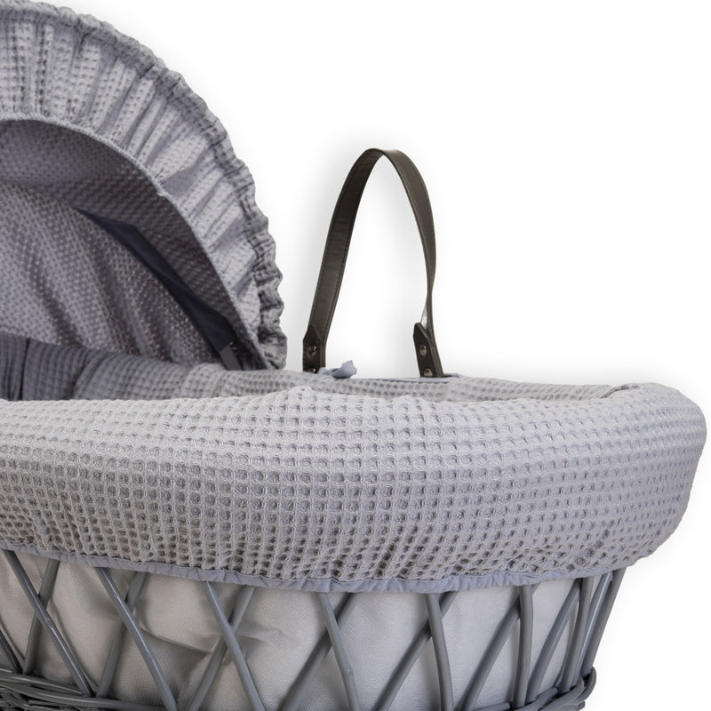 Grey Waffle Grey Wicker Moses Basket showing the sturdy vegan leather carry handles, matching bassinet dressing, hood and coverlet made from the breathable grey waffle fabrics | Co-sleepers | Nursery Furniture - Clair de Lune UK