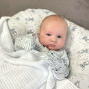 Happy baby in the White Soft Cotton Cellular Cot Blanket | Cosy Baby Blankets & Swaddles | Nursery Bedding | Winter Baby Essentials - Clair de Lune UK