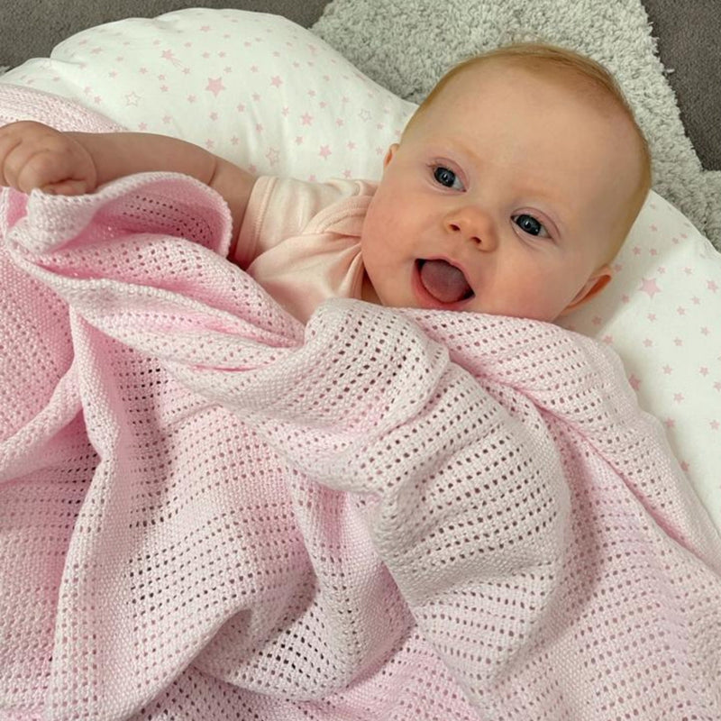 Happy baby in the Pink Soft Cotton Cellular Pram Blanket | Cosy Baby Blankets | Nursery Bedding | Newborn, Baby and Toddler Essentials - Clair de Lune UK
