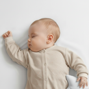 Baby lying on the Micro-Fresh® 2 Pack Fitted Cot Bed Sheets - 137 x 67 cm | Soft Baby Sheets | Cot Bedding - Clair de Lune UK