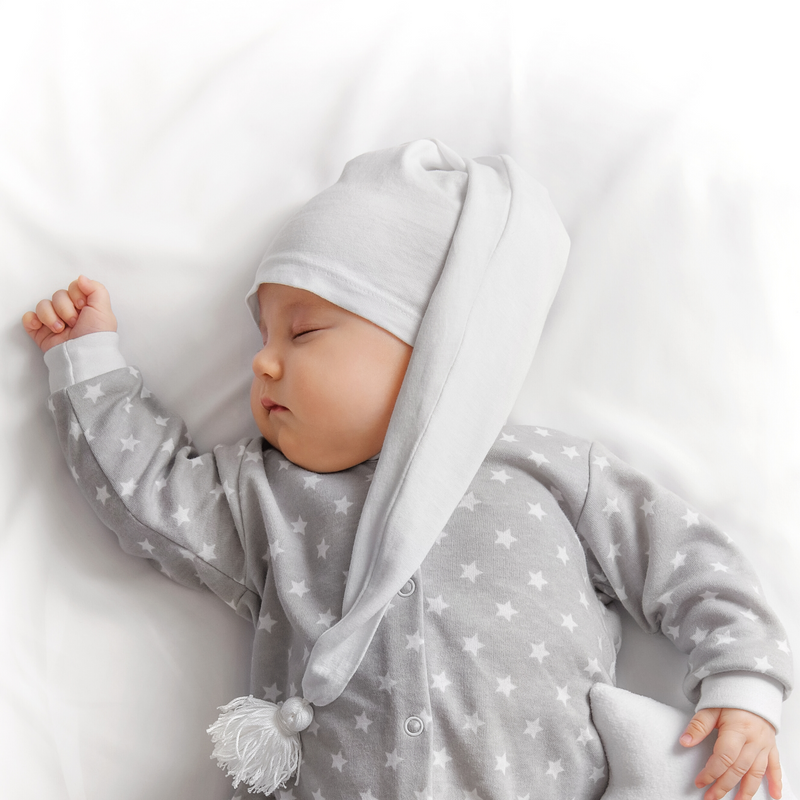Baby sleeping on the Micro-Fresh® 2 Pack White Fitted Travel Cot Sheets - 92 x 60.5 cm | Soft Baby Sheets | Cot, Cot Bed, Pram, Crib & Moses Basket Bedding - Clair de Lune UK