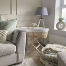 Special Buy - Star Palm Moses Basket with Stand Bundle & Blanket in a stylish beige living room next to the sofa | Moses Baby Baskets, Bassinets | Nursery Furniture - Clair de Lune UK