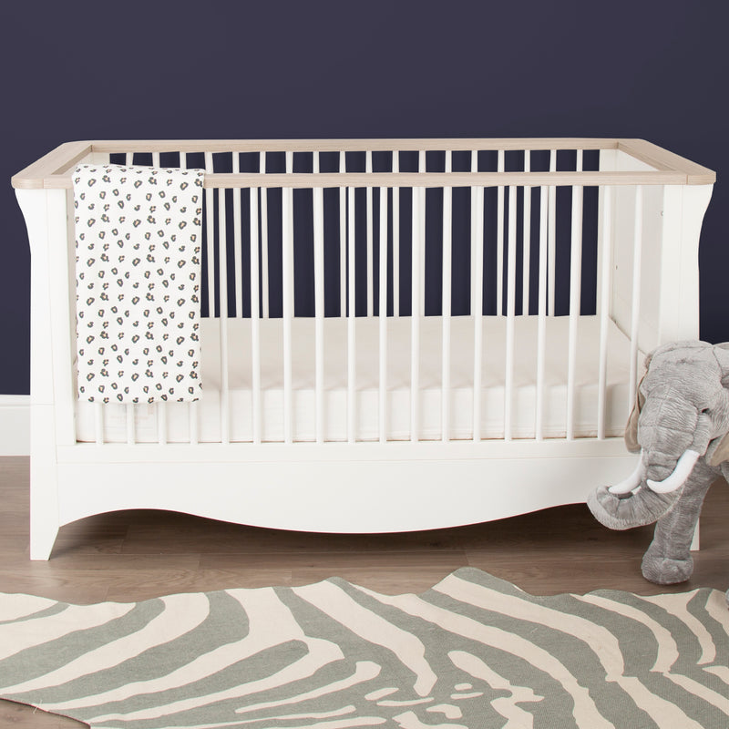 Natural Wood and White CuddleCo Clara Cot Bed in a navy blue nursery | Cots, Cot Beds, Toddler & Kid Beds | Nursery Furniture - Clair de Lune UK