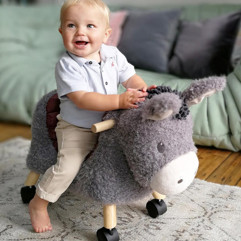 Toddler boy riding his Little Bird Told Me Bojangles Donkey Ride On Toy | Baby Walkers and Ride On Toys | Montessori Activities For Babies & Kids | Toys | Baby Shower, Birthday & Christmas Gifts - Clair de Lune UK