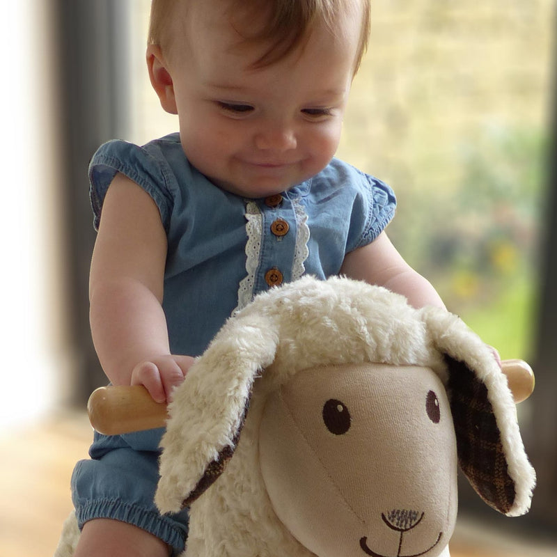  Toddler girl sensing her favourite toy Little Bird Told Me Lambert Rocking Sheep in a traditional Cotswold cottage | Rocking Animals | Montessori Activities For Babies & Kids | Toys | Baby Shower, Birthday & Christmas - Clair de Lune UK