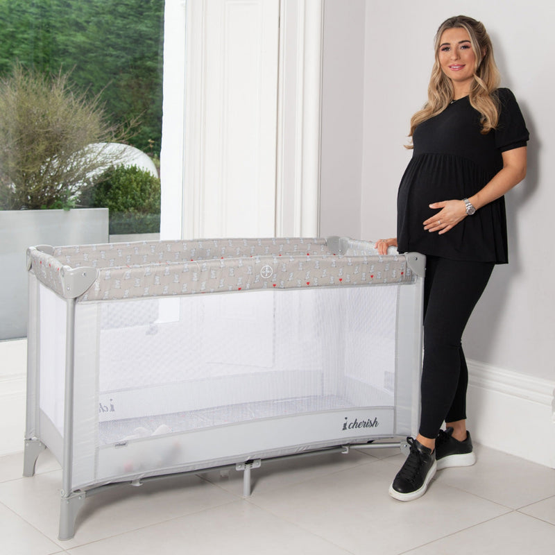 Dani Dyer next to her Grey My Babiie Dani Dyer Elephants Travel Cot | Travel Cots & Travel Bassinets | Cots, Cot Beds, Toddler & Kid Beds | Nursery Furniture - Clair de Lune UK
