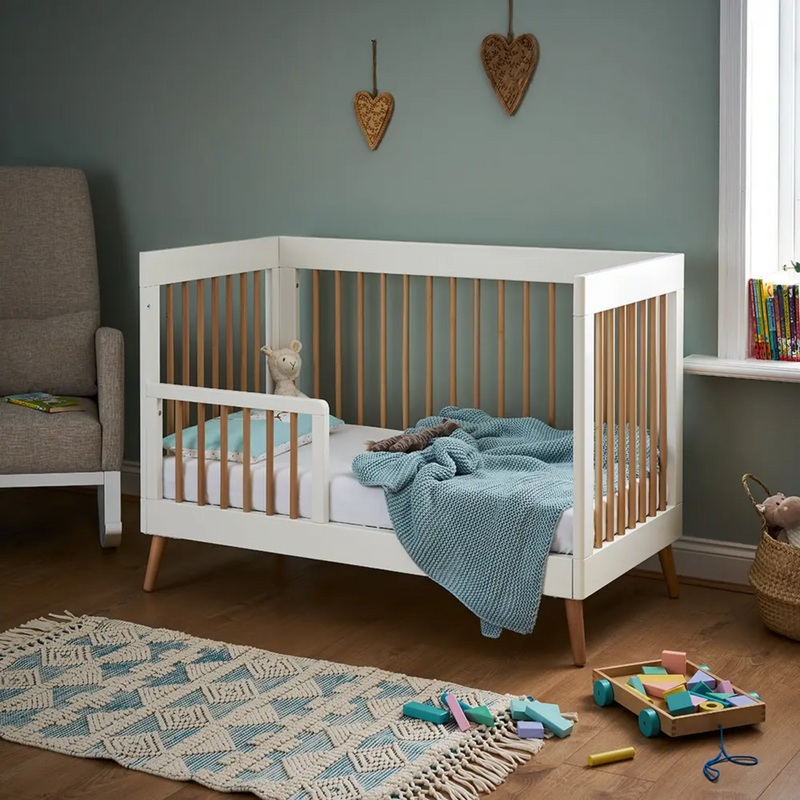 The toddler bed transformation of the White Natural Obaby Award-Winning Maya Mini Cot Bed with the toddler rail in a sage green nursery room | Cots, Cot Beds, Toddler & Kid Beds | Nursery Furniture - Clair de Lune UK