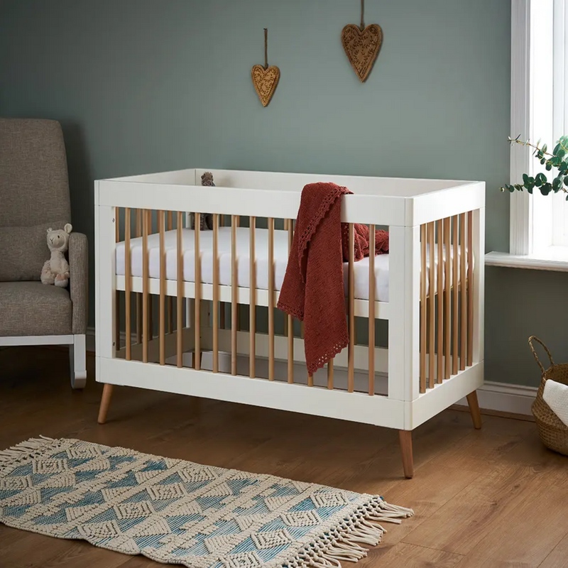 The cot bed of the White Obaby Maya Mini 3 Piece Room Set with an adjustable platform | Nursery Furniture Sets | Room Sets | Nursery Furniture - Clair de Lune UK