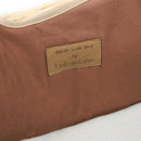 Rust Orange Organic Natural Noah Pod with the brown vegan leather label zoomed in | Moses Baby Baskets & Bassinets | Nursery Furniture - Clair de Lune UK