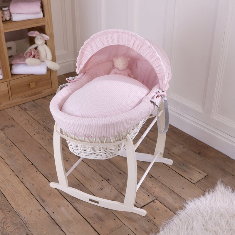 Pink Waffle White Wicker Moses Basket on the White Deluxe Rocking Stand in a minimalist bedroom | Co-sleepers | Nursery Furniture - Clair de Lune UK