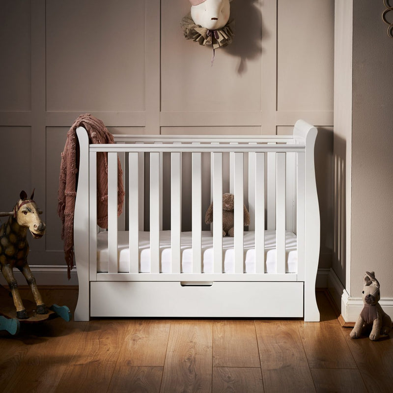 The white Obaby Stamford Space Saver Cot in gender-neutral nursery room | Cots, Cot Beds, Toddler & Kid Beds | Nursery Furniture - Clair de Lune UK