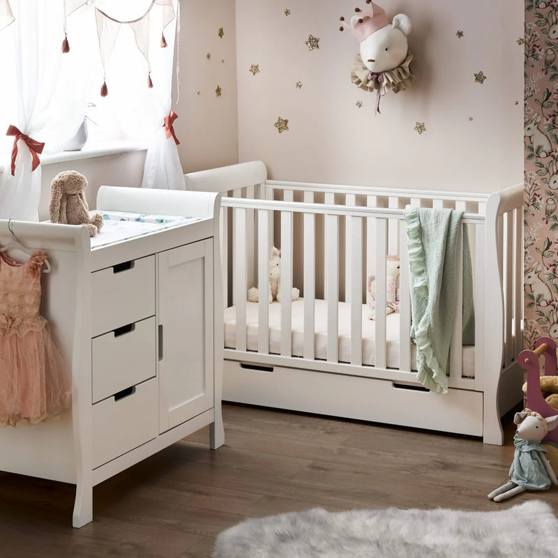 The changing unit and cot bed of the White Obaby Stamford Mini 3 Piece Room Set in a princess inspired nursery room | Nursery Furniture Sets | Room Sets | Nursery Furniture - Clair de Lune UK