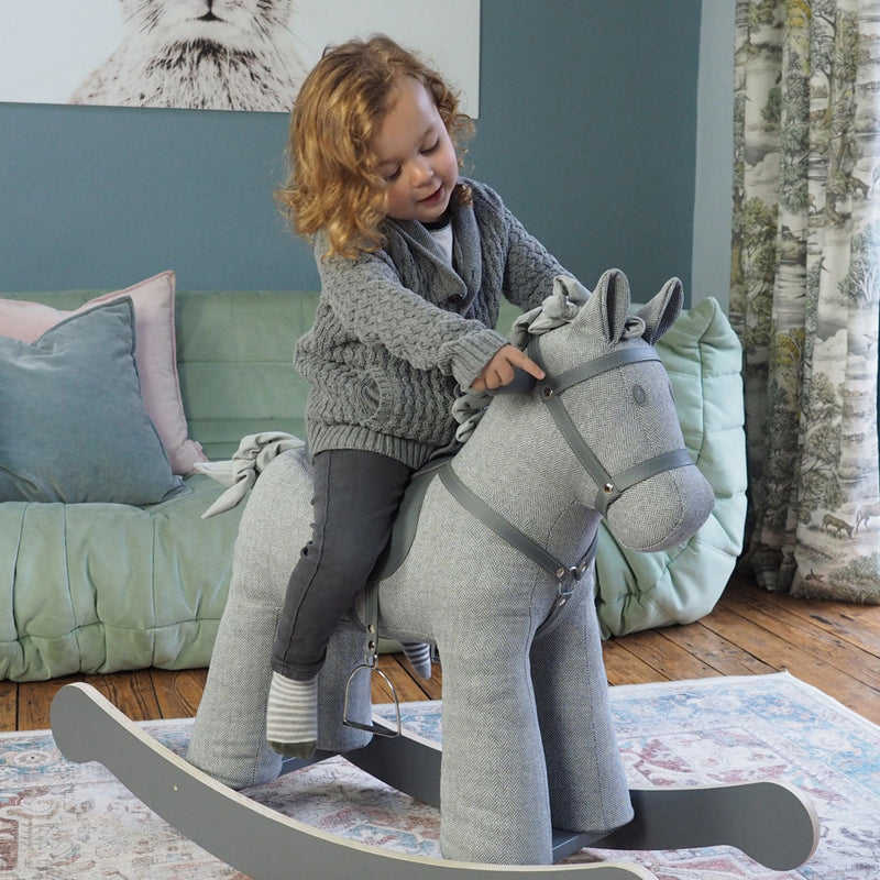 Little boy sensing the softness of the Little Bird Told Me Stirling Rocking Horse | Rocking Animals | Montessori Activities For Babies & Kids | Toys | Baby Shower, Birthday & Christmas - Clair de Lune UK 