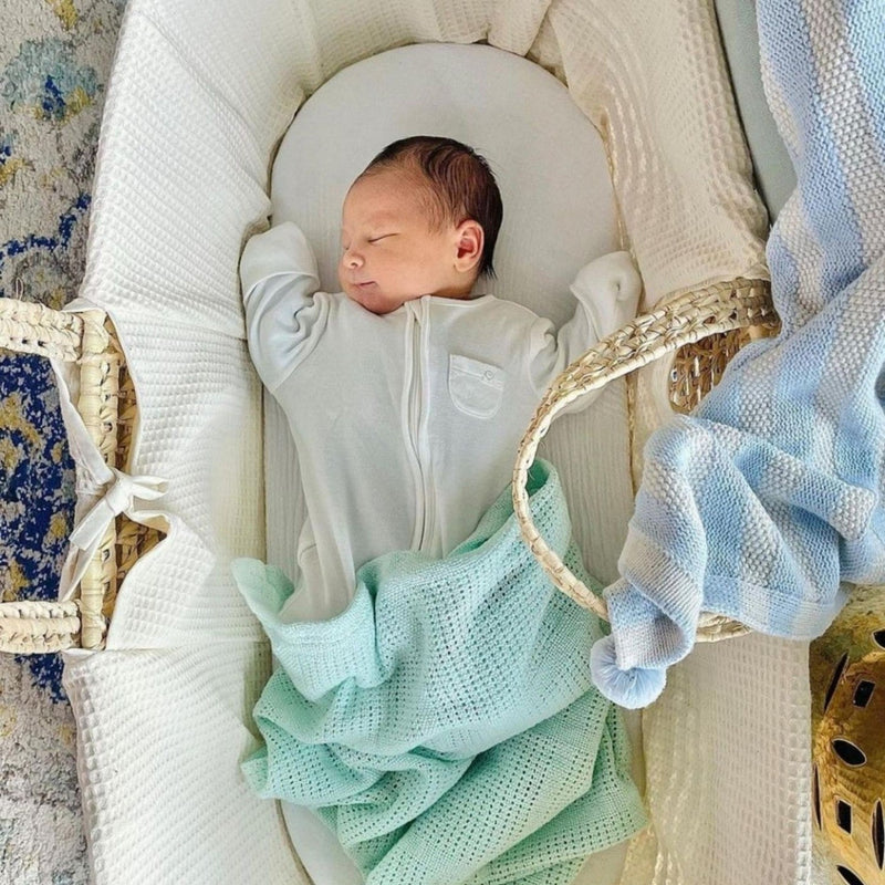 Baby sleeping well inside the Cream Waffle Palm Moses Basket | Moses Baskets | Co-sleepers | Nursery Furniture - Clair de Lune UK