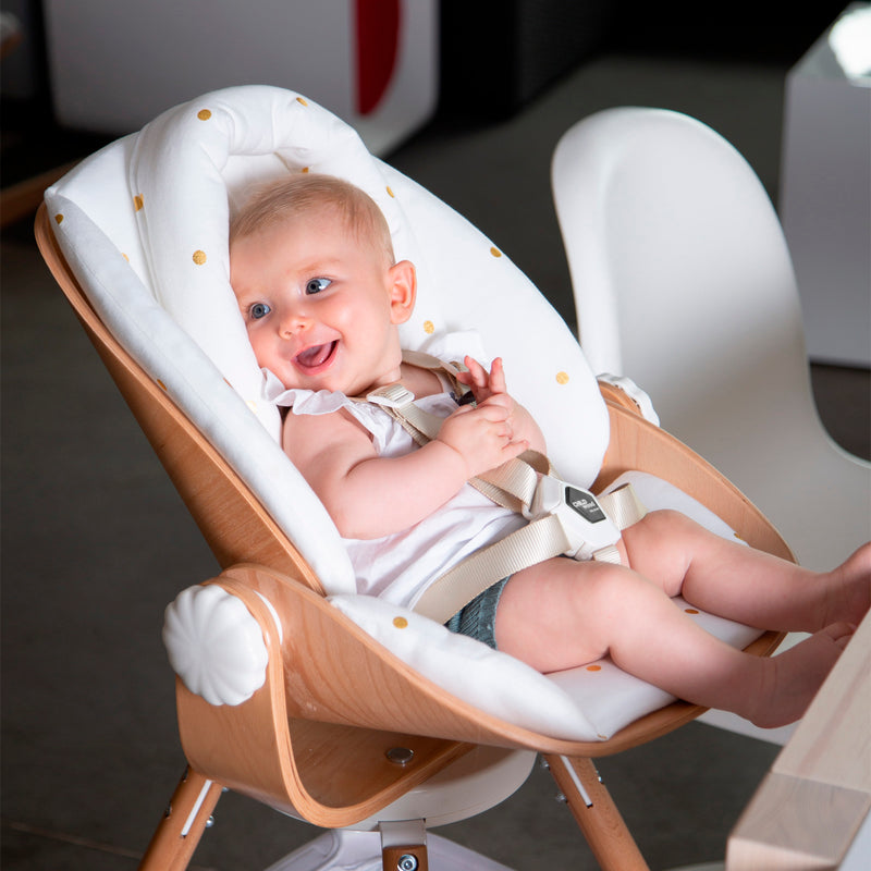 Smiling baby sitting on the Natural/White Childhome Evolu Newborn Seat (For Evolu & One80°) | Highchairs | Feeding & Weaning - Clair de Lune UK