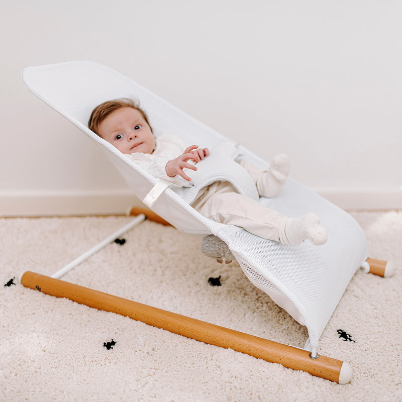 Baby playing on the Natural/Anthracite Childhome Evolux Baby Bouncer | Baby Swings, Rockers & Baby Bouncers | Toys - Clair de Lune