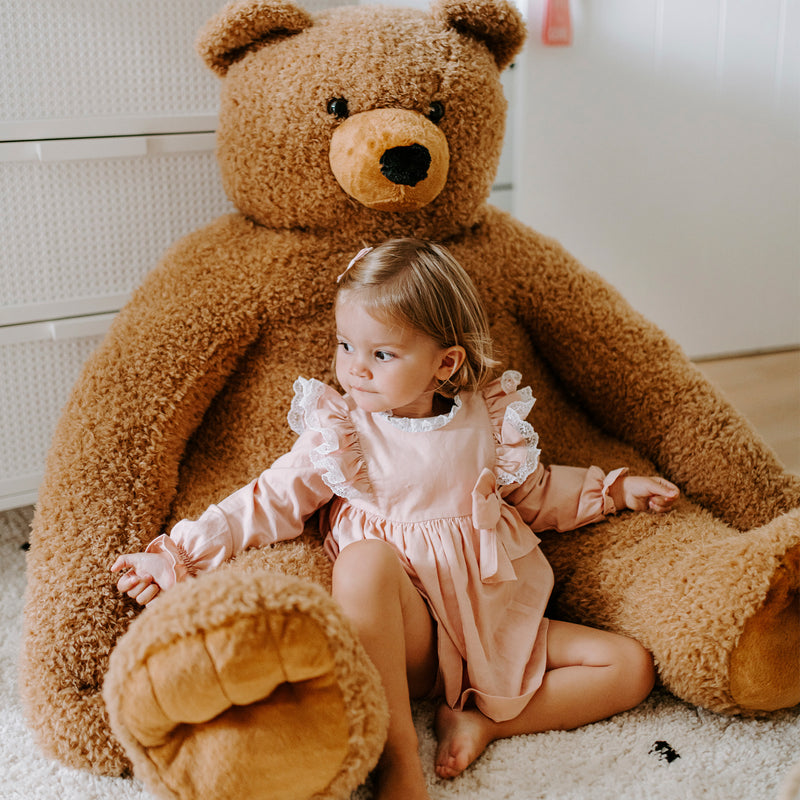 Little girl playing with the Childhome Sitting Teddy | Bear Toys | Baby Shower, Birthday & Christmas Gifts - Clair de Lune UK